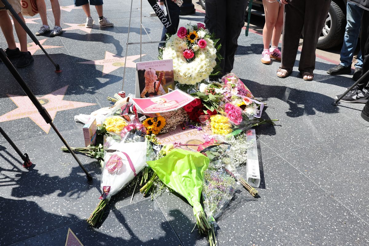 Flowers are laid on Dolly Parton's star on the Hollywood Walk of Fame on August 25, 2026, in Los Angeles, California