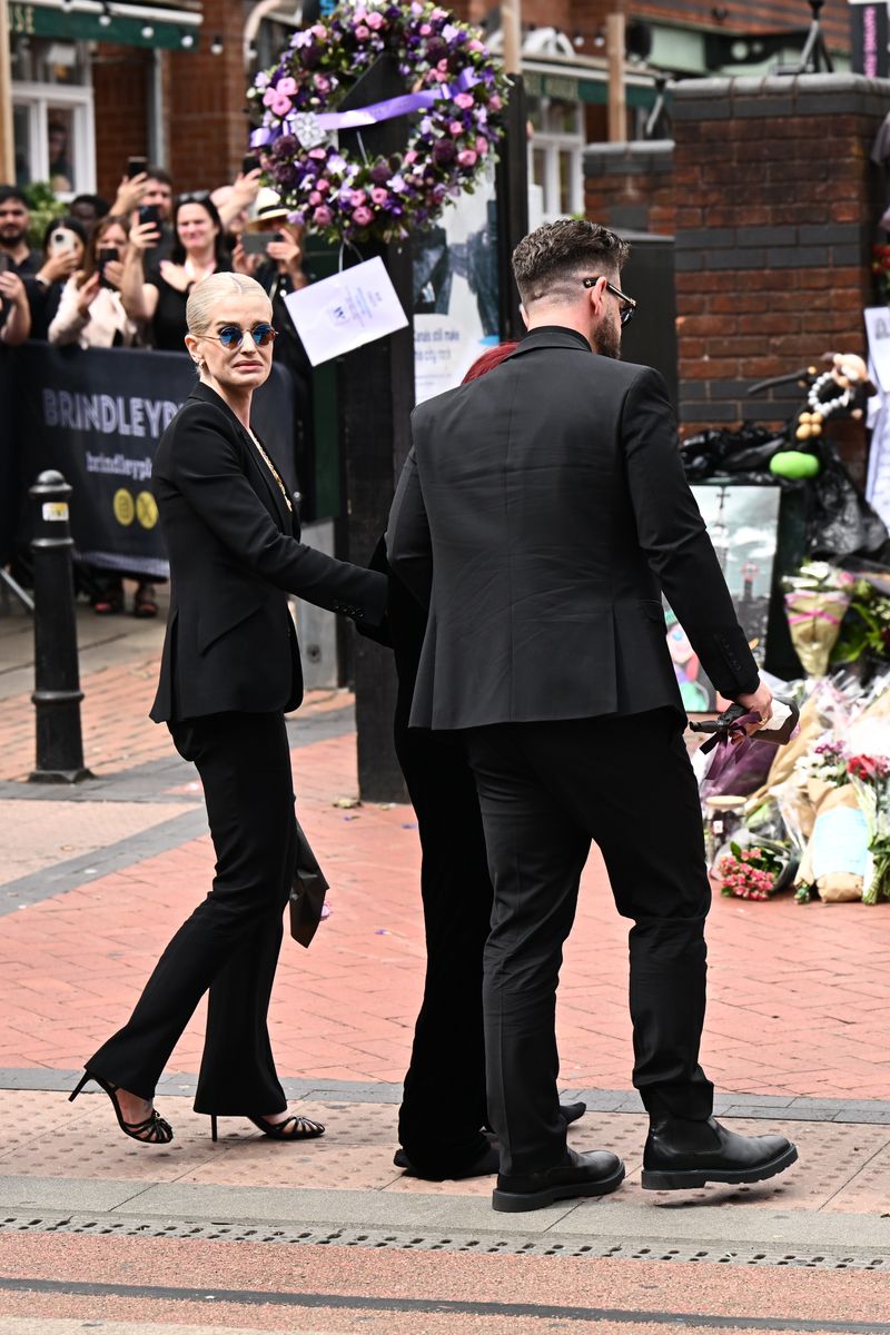 (L-R) Kelly Osbourne, Sharon Osbourne, and Jack Osbourne arrive to view tributes to the late Ozzy Osbourne from fans as his funeral cortege travels through his home city of Birmingham.