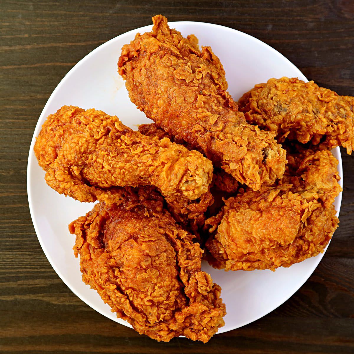 Plate of Delectable Golden Brown Crispy Fried Chickens on Wooden Background
