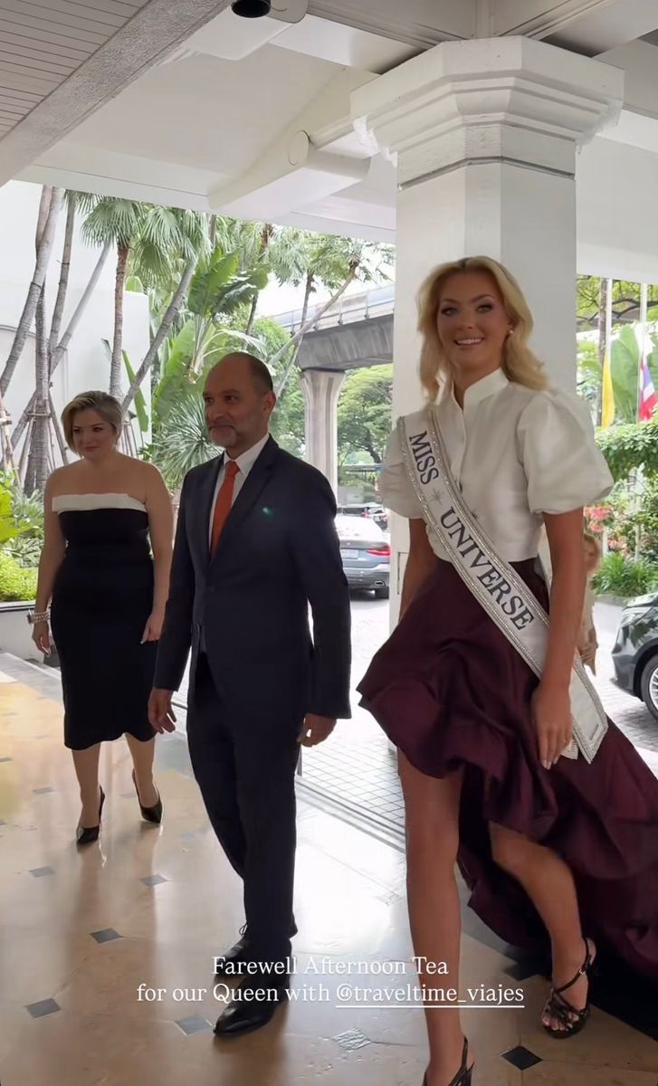 She’s wearing a crisp white blouse with structured puff sleeves that give her a clean, modern edge.