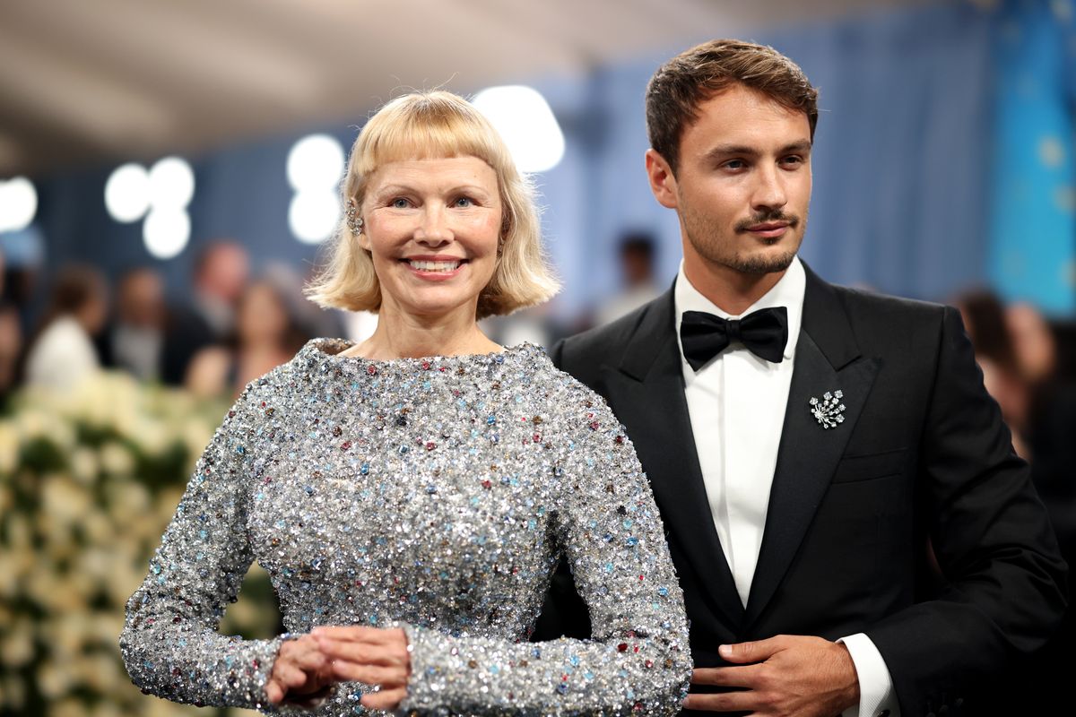 Pamela Anderson and Brandon Thomas Lee attend the 2025 Met Gala Celebrating "Superfine: Tailoring Black Style" 