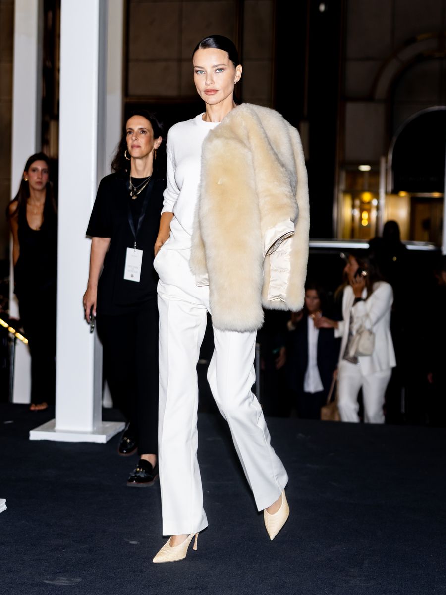 The former Victoria’s Secret Angel paired wide-leg trousers and pointed heels with an oversized cream coat during New York Fashion Week.
