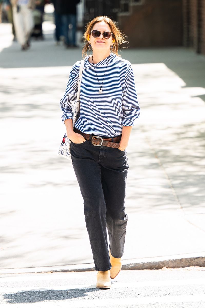 Perhaps no outfit defines her aesthetic better than her classic striped top and high-waisted black denim combination. 