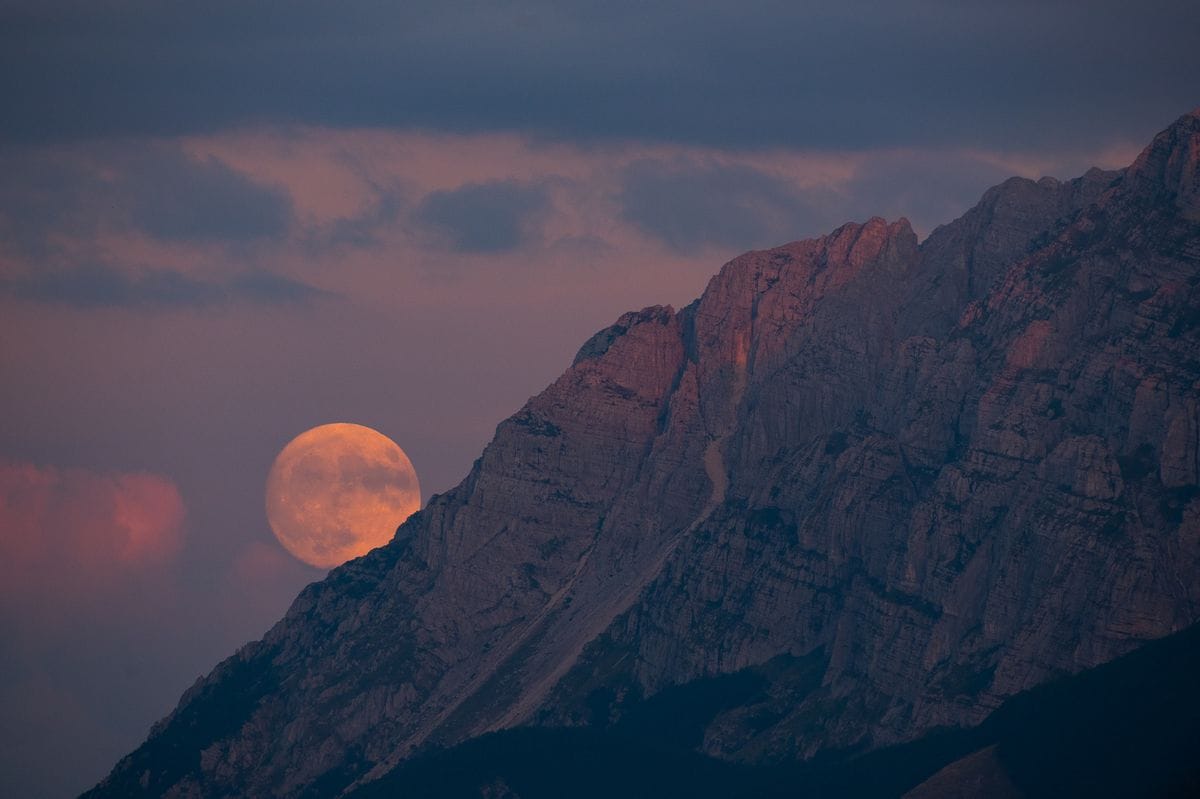 Sturgeon full super moon rising behind Sirente mountain is seen from Rocca Di Cambio (L'Aquila, Abruzzo), Italy on July 31, 2023.