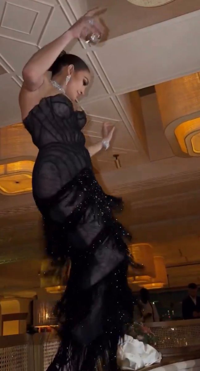 The star embraced old Hollywood glamour in a corseted black gown featuring a sheer bodice and shimmering fringe skirt.