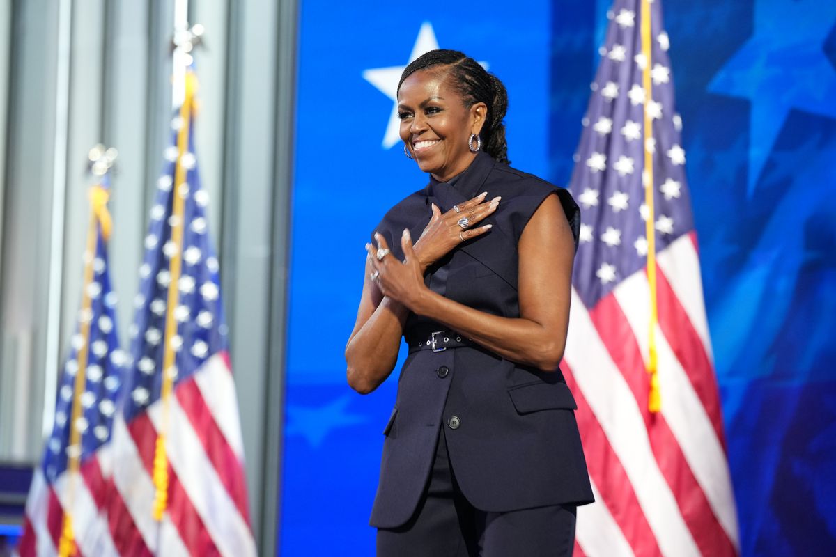 Former first lady Michelle Obama arrives to speak on stage during the second day of the Democratic National Convention