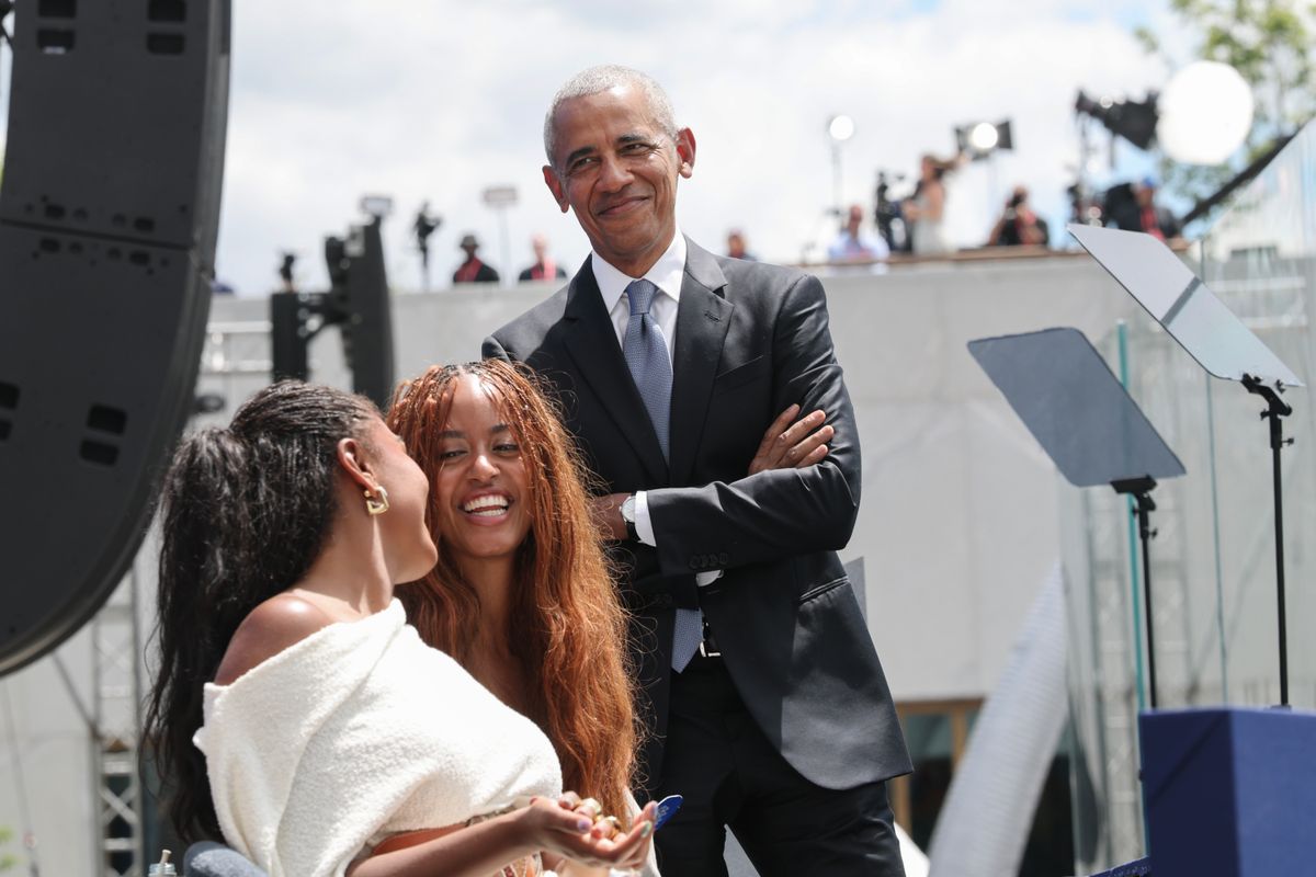 Barack Obama stage alongside his daughters Sasha and Malia
