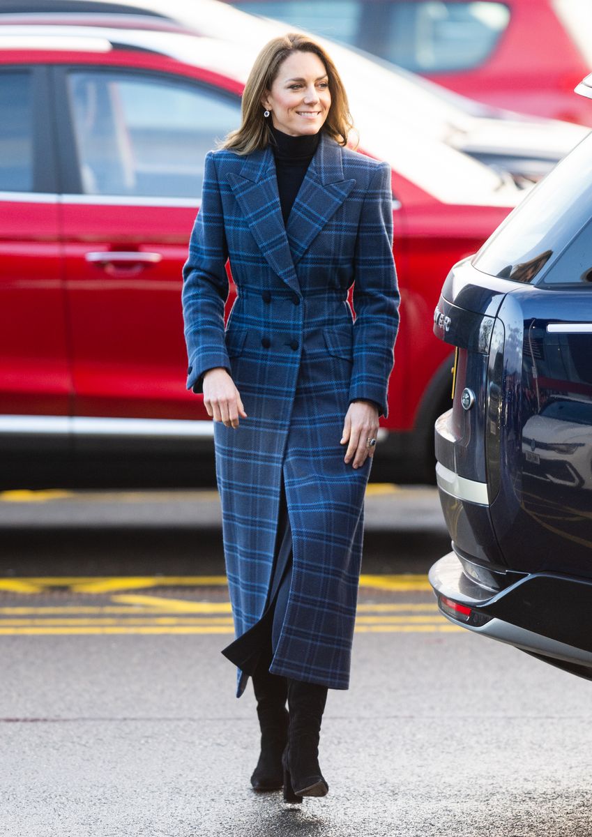 The Princess of Wales elevated her winter wardrobe with a tailored blue plaid coat and black turtleneck during a visit to the National Curling Academy in Stirling, Scotland.