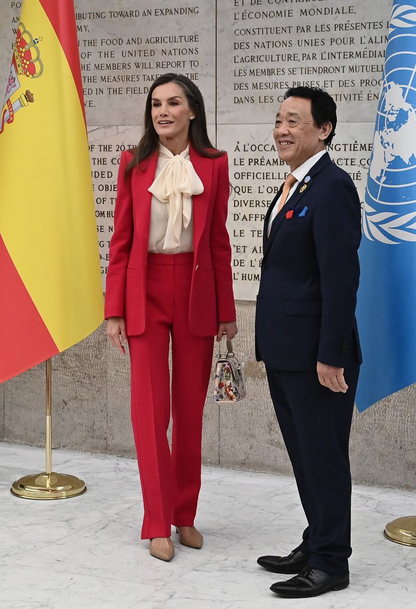 Queen Letizia paired the suit with a blouse featuring a delicate necktie.