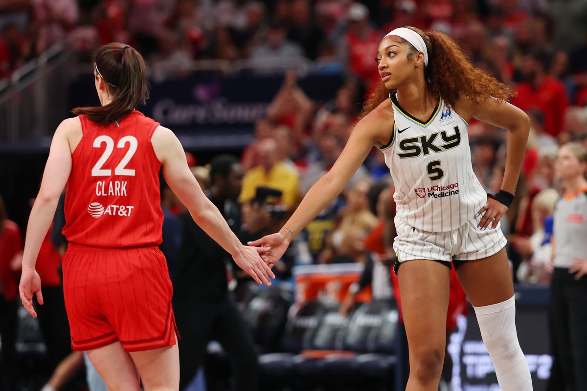  Angel Reese #5 of the Chicago Sky and Caitlin Clark #22 of the Indiana Fever meet at midcourt prior to tipoff for the Fever's home opener at Gainbridge Fieldhouse on May 17, 2025, in Indianapolis, Indiana. 