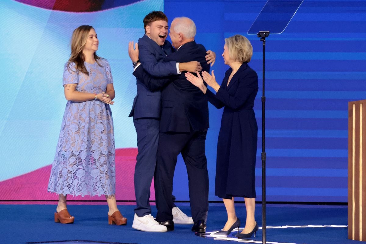 Democratic vice presidential nominee Minnesota Gov. Tim Walz and his son Gus embrace. At the same time, his wife Gwen, right, and daughter Hope, left, look on during the Democratic National Convention on Wednesday, Aug. 21, 2024, in Chicago, IL. (Myung J. Chun/Los Angeles Times via Getty Images)