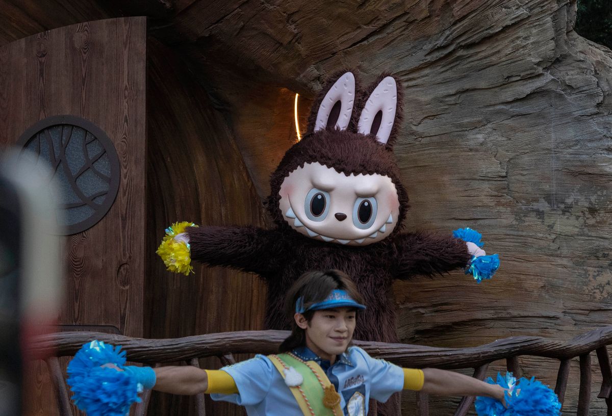 A performer wears a costume of the Labubu character while dancing for visitors at the Pop Land theme park in China.