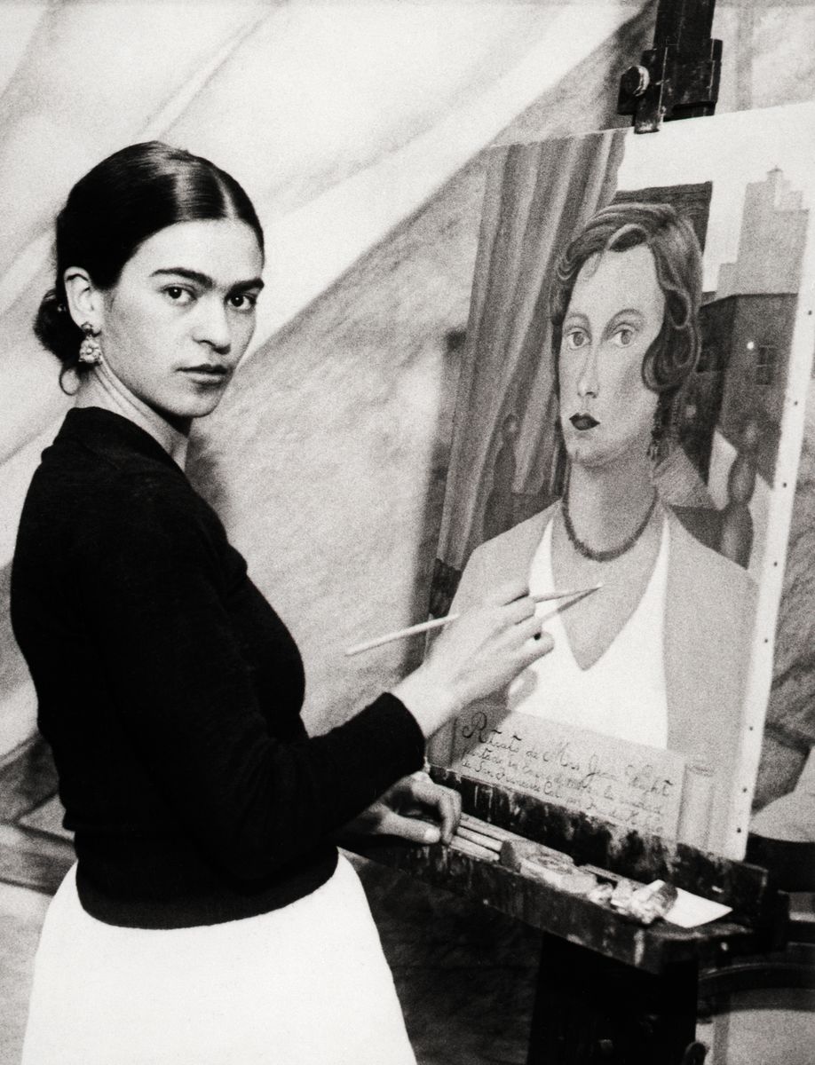 When questioned on his wife's artistic ability, the famous artist's answer was "Quien Sabe? I do not look at it." Photo shows Frida doing a mural for the San Francisco Stock Exchange.