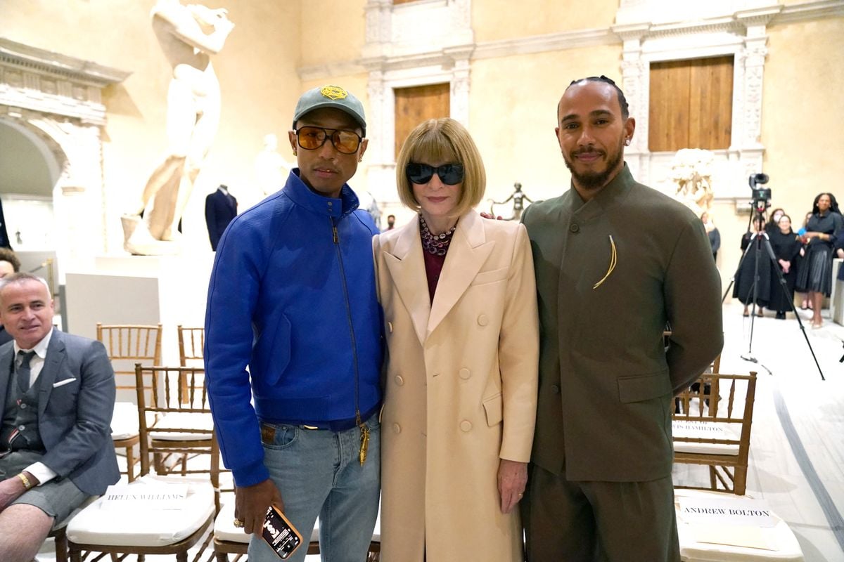 Met Gala celebrity Pharrell Williams and Lewis Hamilton pose with Vogue editor Anna Wintour at the Metropolitan Museum of Art's Costume Institute during a press conference October 9, 2024 to announce the Met Gala theme "Superfine: Tailoring Black Style," that will be launched by the Met Gala on May 5. 