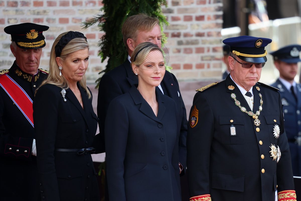 Charlene wore a black Dior ensemble featuring the fashion house’s iconic Bar jacket for the solemn occasion.