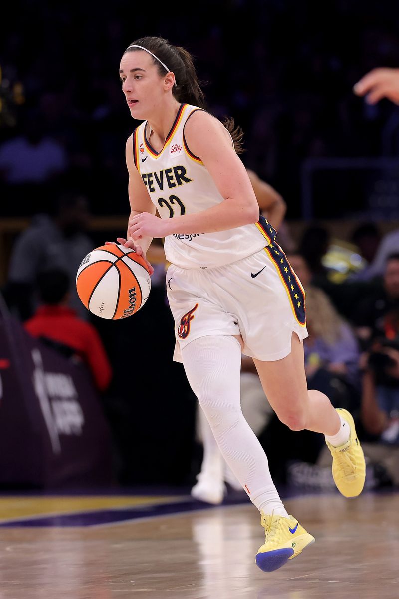 Caitlin Clark #22 of the Indiana Fever brings the ball up court during the fourth quarter of the game against the Los Angeles Sparks