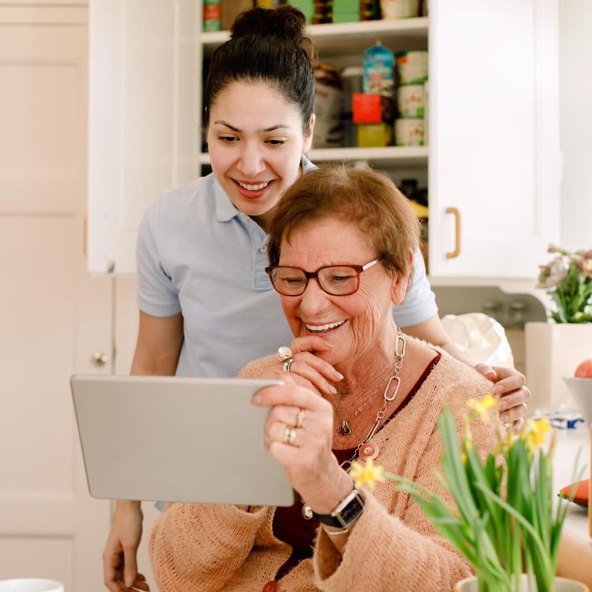 Woman helping elder woman