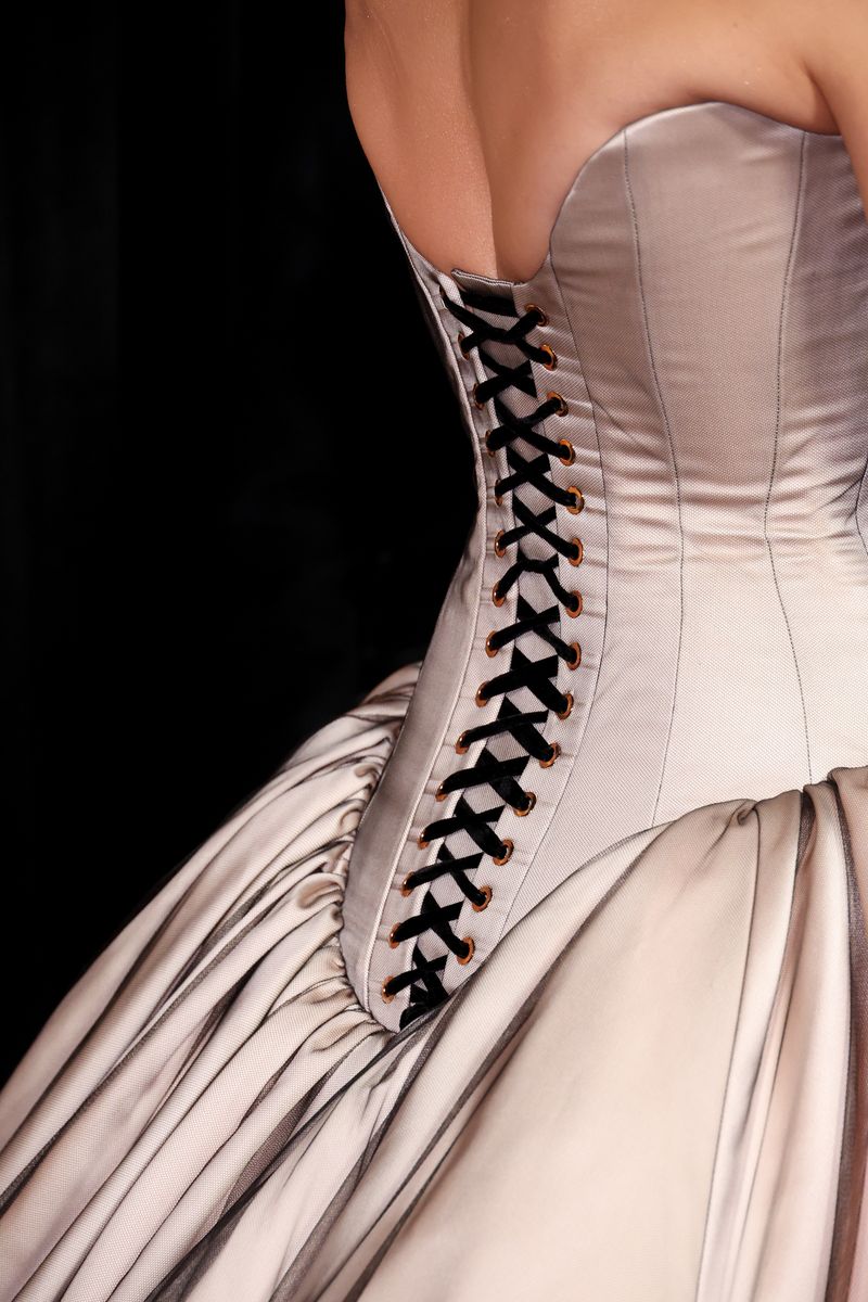 The black ribbon weaving against the pale fabric added contrast and depth, turning the back of the dress into its own visual moment.