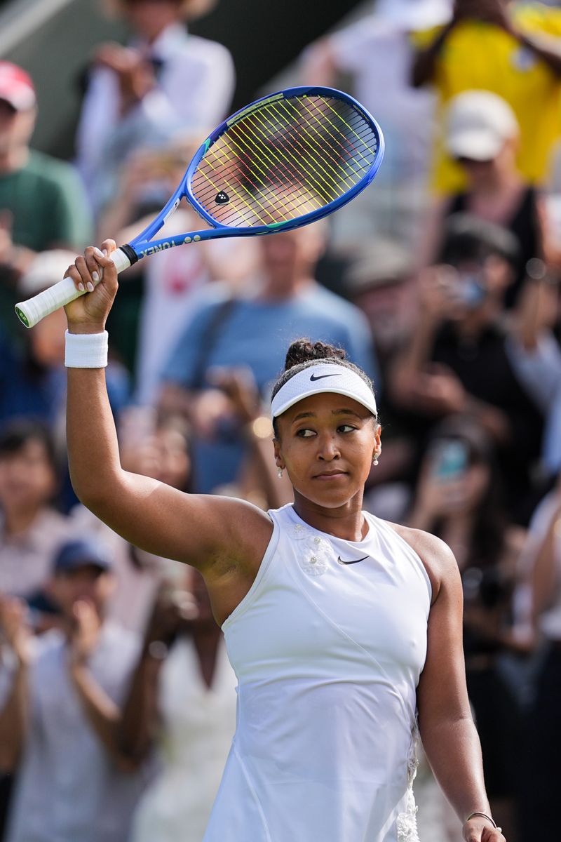 Naomi Osaka of Japan celebrates the victory in her Ladies Singles first round match against Elsa Jacquemot of France.