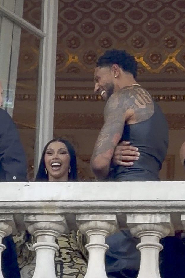 Rapper and singer Cardi B is spotted with Nigerian soccer goalkeeper, Maduka Okoye enjoying a drink while relaxing at an event on a balcony overlooking the city.
