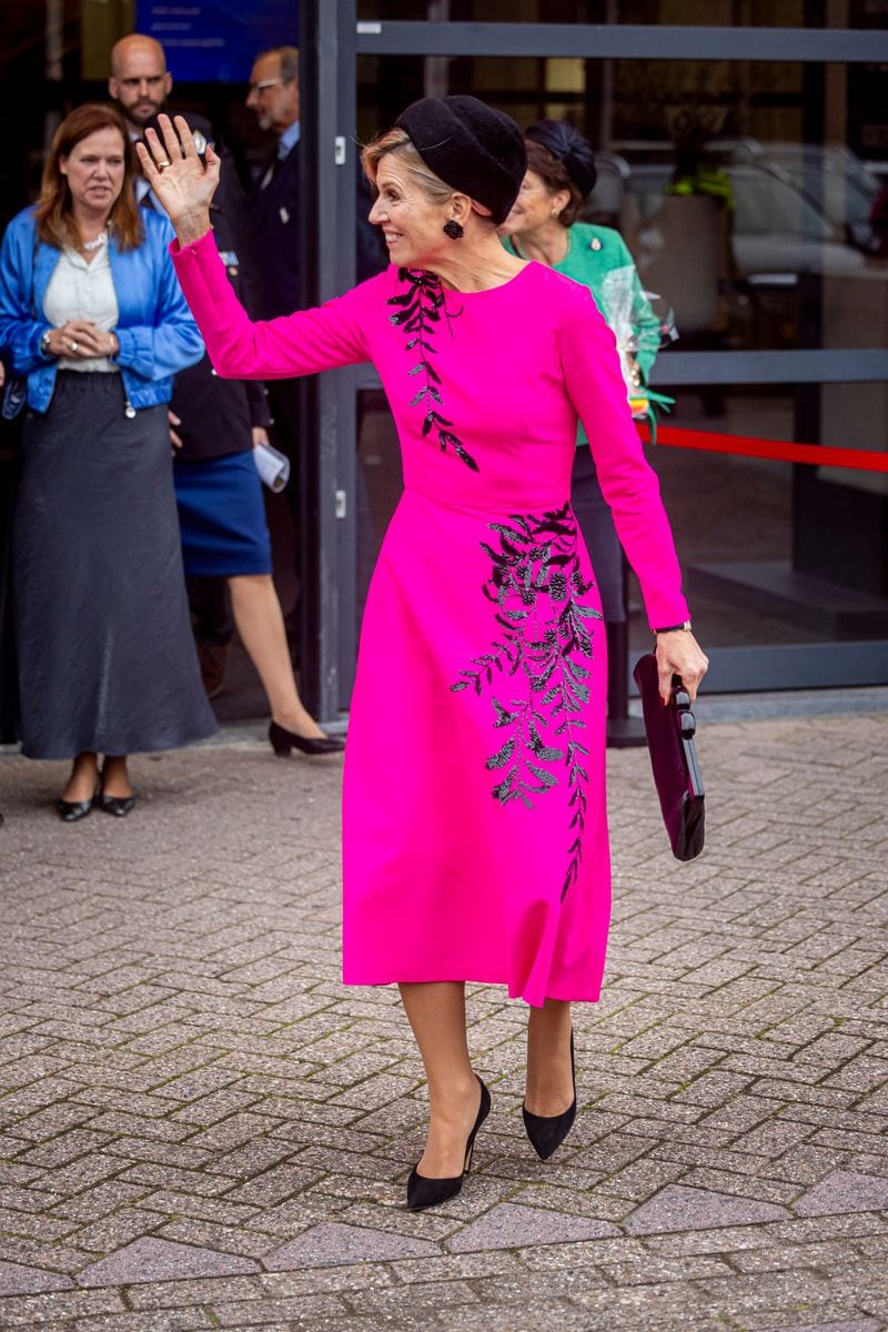 Queen Maxima of The Netherlands stepped out in a fuchsia Oscar de la Renta midi dress, paired with towering heels and an eye-catching feathered fascinator.