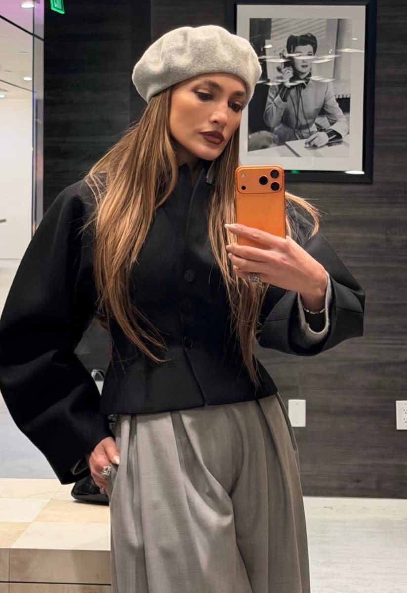 Lopez showcased her outfit in full, featuring a collarless black jacket buttoned neatly over her torso