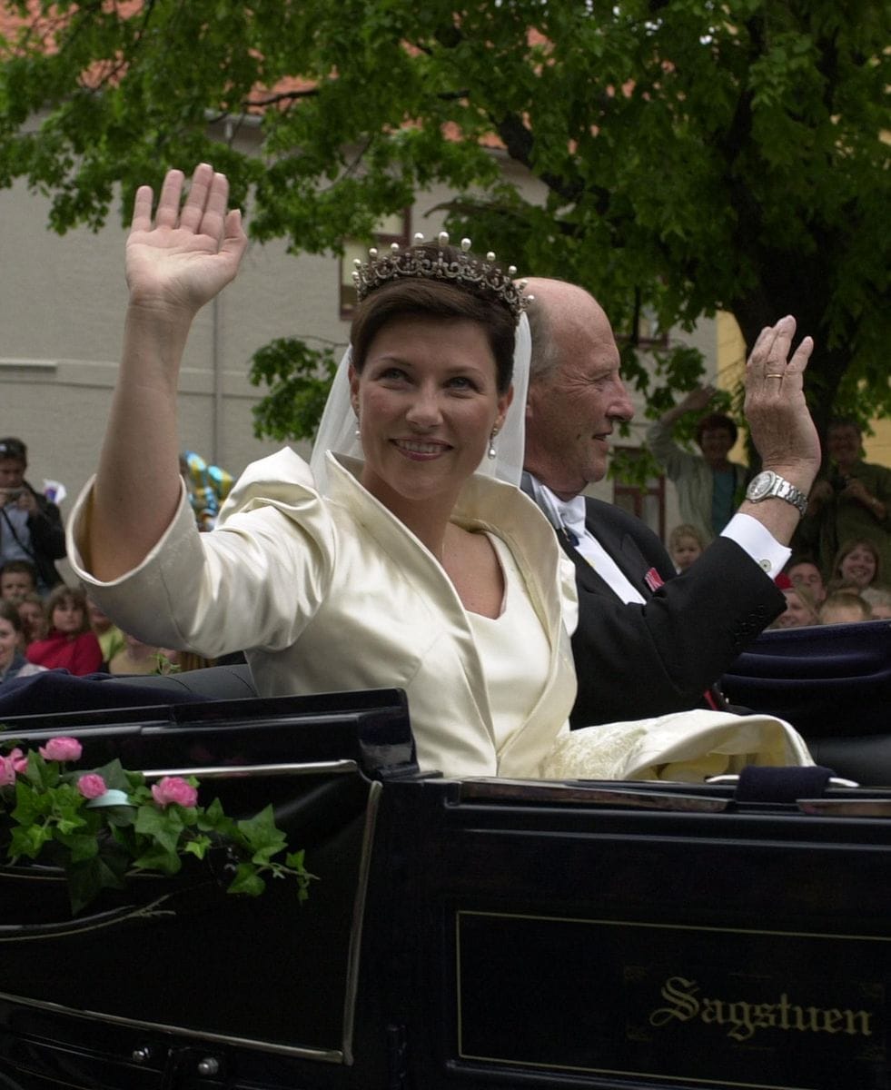 Princess Martha Louise and her father King Harald of Norway wave as they arrive in a horse drawn carriage outside Trondheim Cathedral