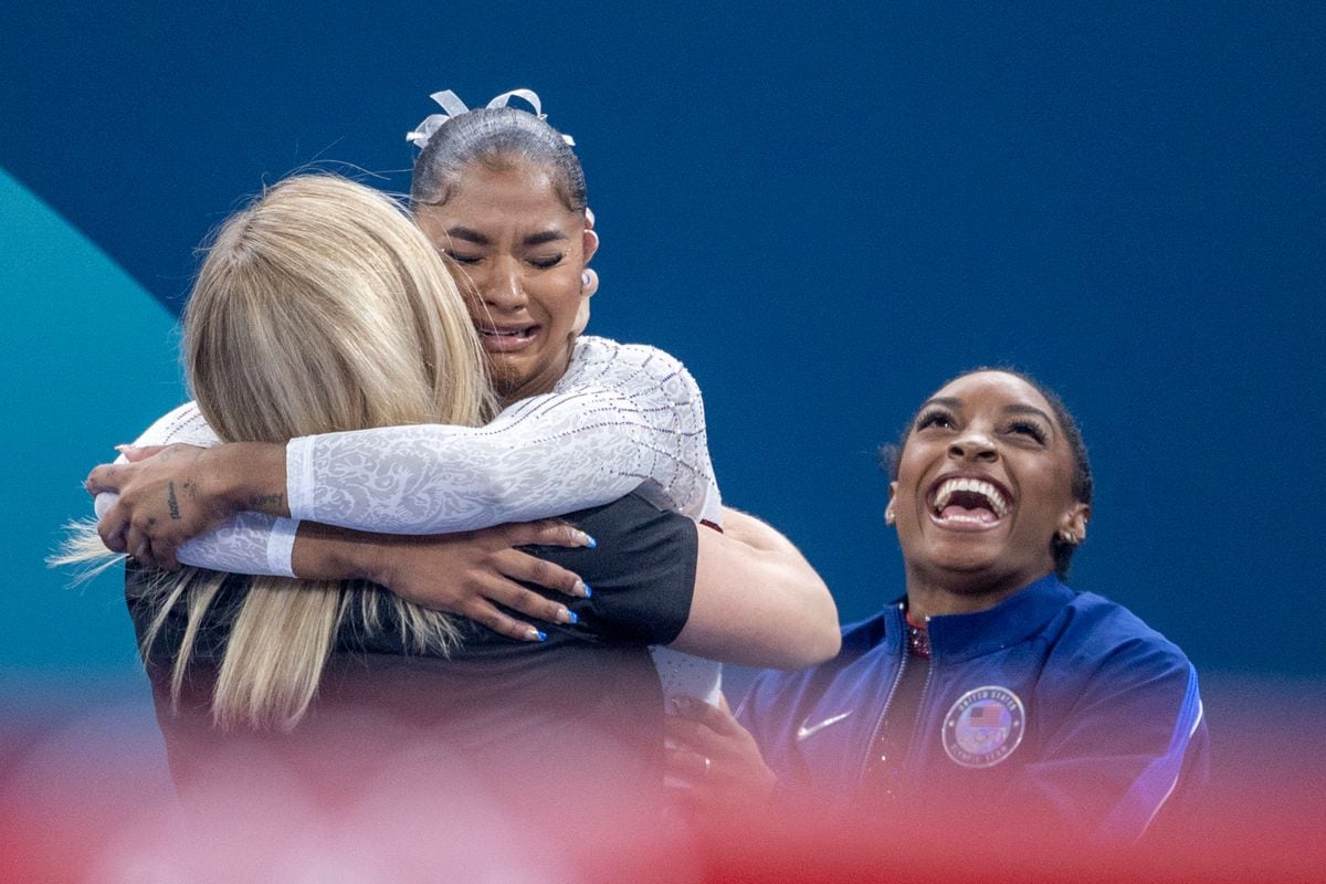 Jordan Chiles of the United States is congratulated by coach Cecile Landi and teammate Simone Biles.