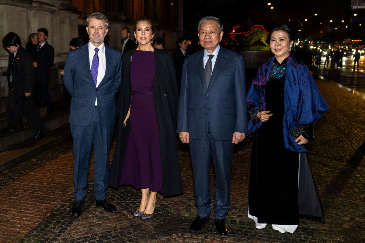 Queen Mary opted for a sophisticated plum-colored dress by Roland Mouret, paired with a long black coat and embellished heels for an evening reception.