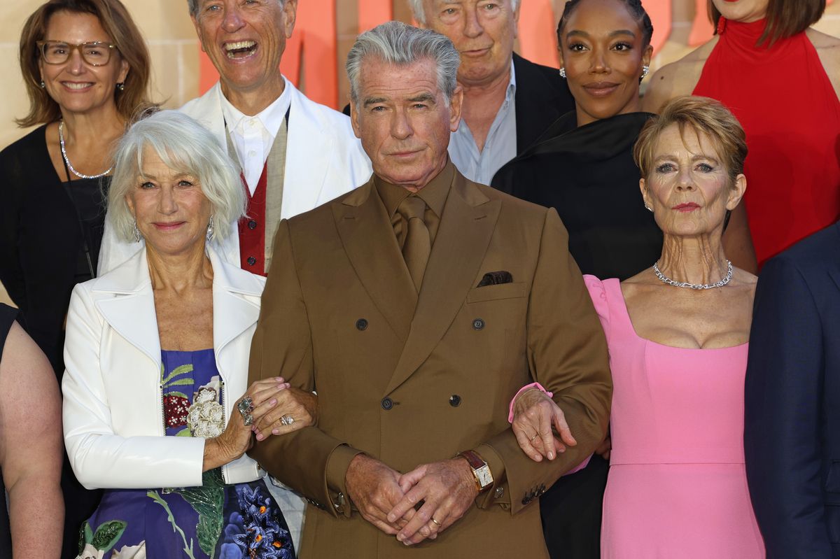 (L-R) Holly Bario, President, Amblin Entertainment, Dame Helen Mirren, Richard E. Grant, Pierce Brosnan, Paul Freeman, Naomi Ackie and Celia Imrie.