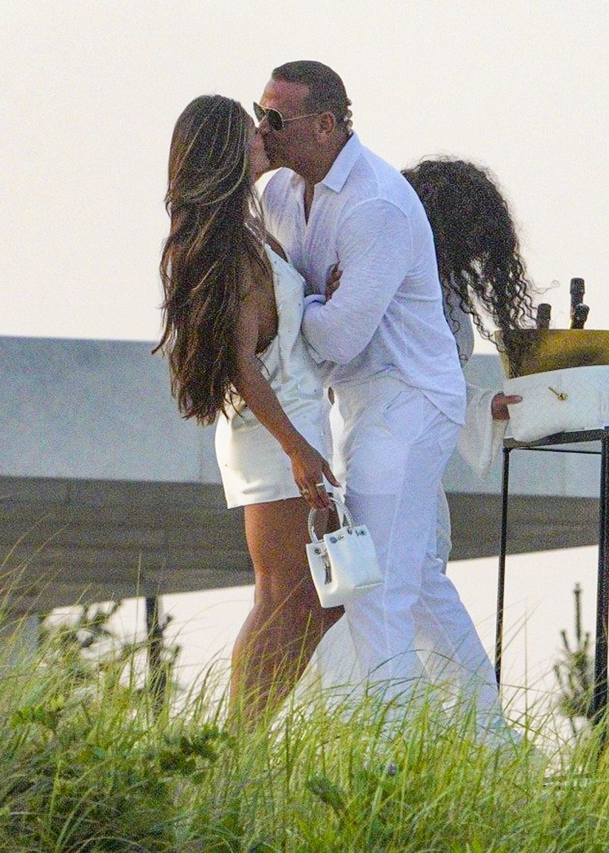 Rodriguez and his companion smiled and chatted between affectionate moments while dressed in coordinated all-white looks.