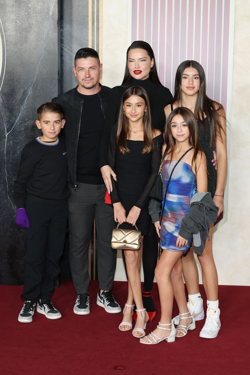 Andre Lemmer, Adriana Lima and children attend the Los Angeles premiere of "The Hunger Games: The Ballad Of Songbirds & Snakes"