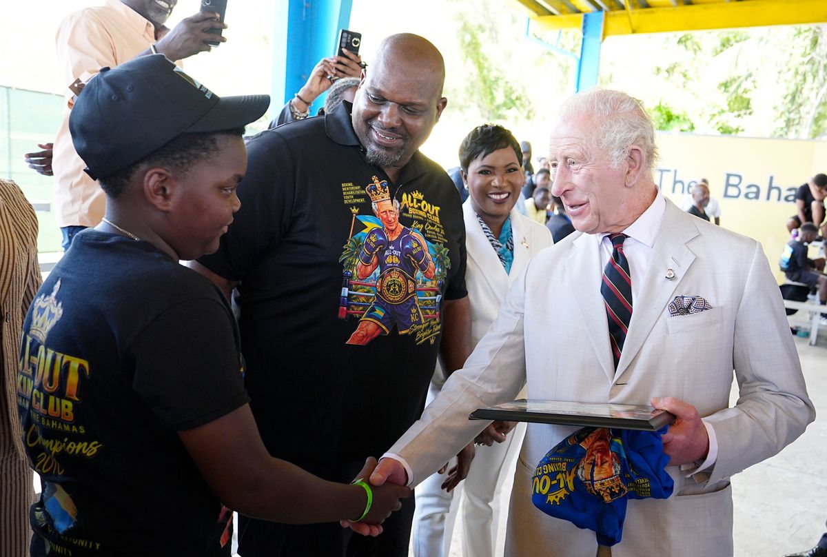 King Charles III meets 12-year-old Sanai Miller and boxing coach Jermaine Gibson during a visit to The Bahamas Boxing Academy as part of the royal visit to the Bahamas 