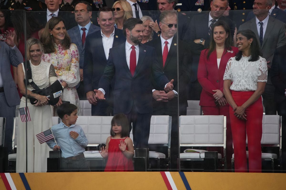 WASHINGTON, DC - JUNE 14: Vice President JD Vance gestures to his wife Usha Vance as they watch the military parade on June 14, 2025 in Washington, DC.   The U.S. Army is marking its 250th anniversary with a military parade along Constitution Avenue that includes roughly 6,600 troops, 150 vehicles, and over 50 aircraft.  The parade, which coincides with President Donald Trump's 79th birthday, is designed to tell the history of the Army. (Photo by Andrew Harnik/Getty Images)
