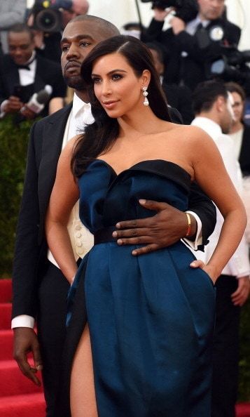 Kanye was affectionate as ever with Kim at the Costume Institute Benefit at The Metropolitan Museum of Art in New York on May 5, 2014. The reality star wore a jewel-toned Lanvin strapless gown and Kanye rocked a tuxedo by the same designer.
<br>
Photo: Getty Images