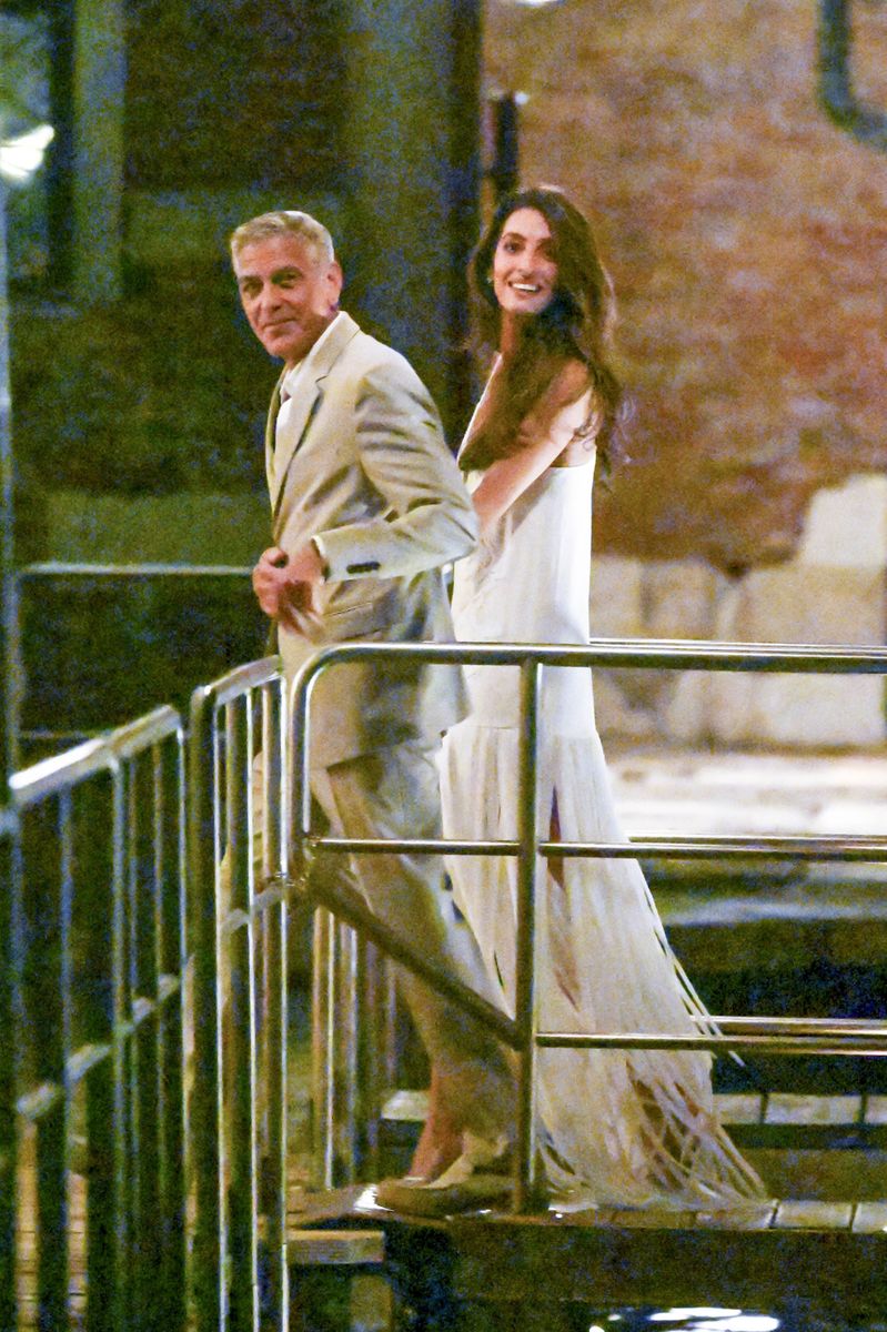 Amal wore a flowing white maxi dress featuring a sleek silhouette and dramatic layers of fringe.
