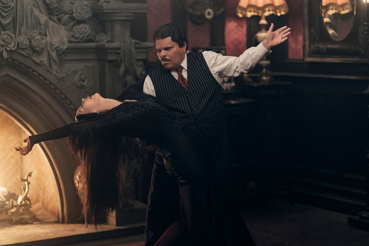 Catherine Zeta-Jones and Luis Guzman as Morticia and Gomez Addams