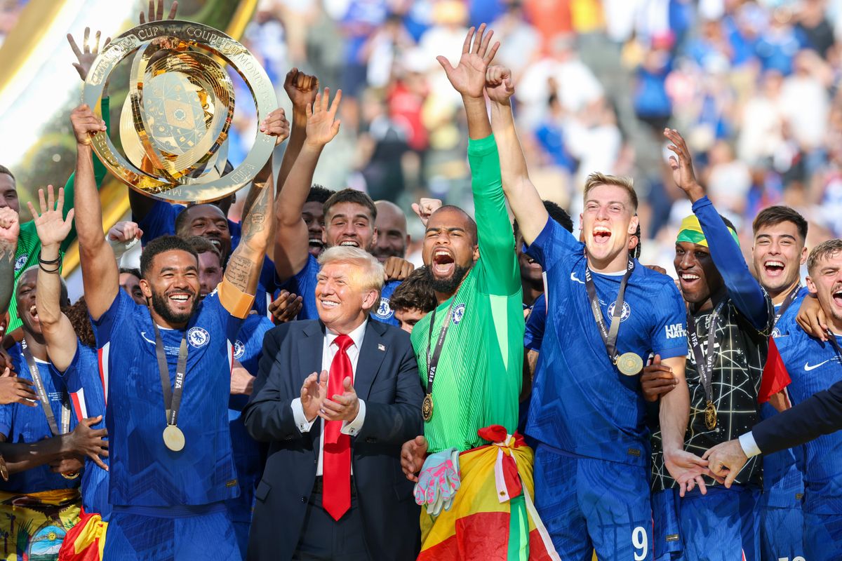 Reece James of Chelsea lifts the FIFA Club World Cup trophy, with US President Donald Trump on the stage, after their team's victory following the FIFA Club World Cup 2025 Final match between Chelsea FC and Paris Saint-Germain 