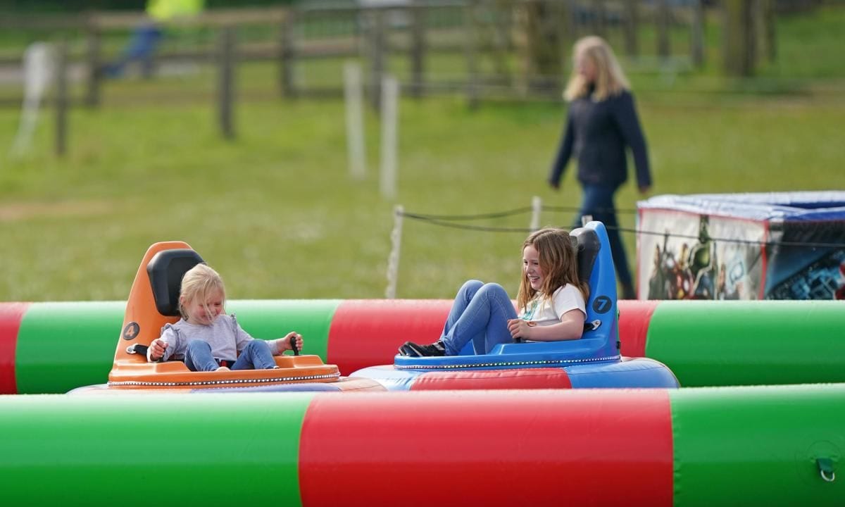 Sisters Mia and Lena laughed as they rode bumper cars.