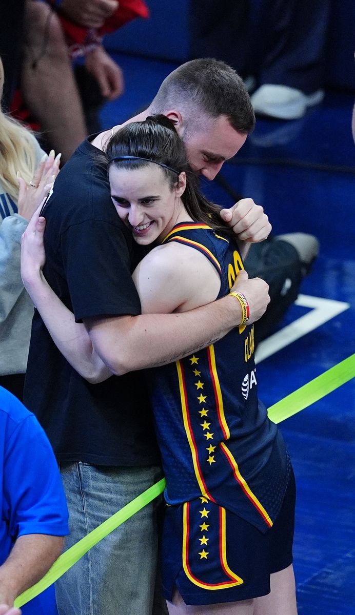 Indiana Fever  guard Caitlin Clark (22) gets a hug from her boyfriend Connor McCaffery after winning a game against the New York Liberty