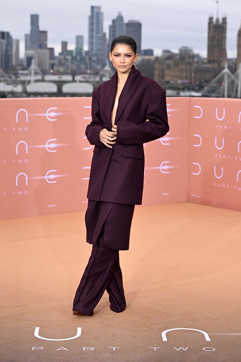  Zendaya wearing an oversized outfit of the same tone combined with her hair up and soft makeup