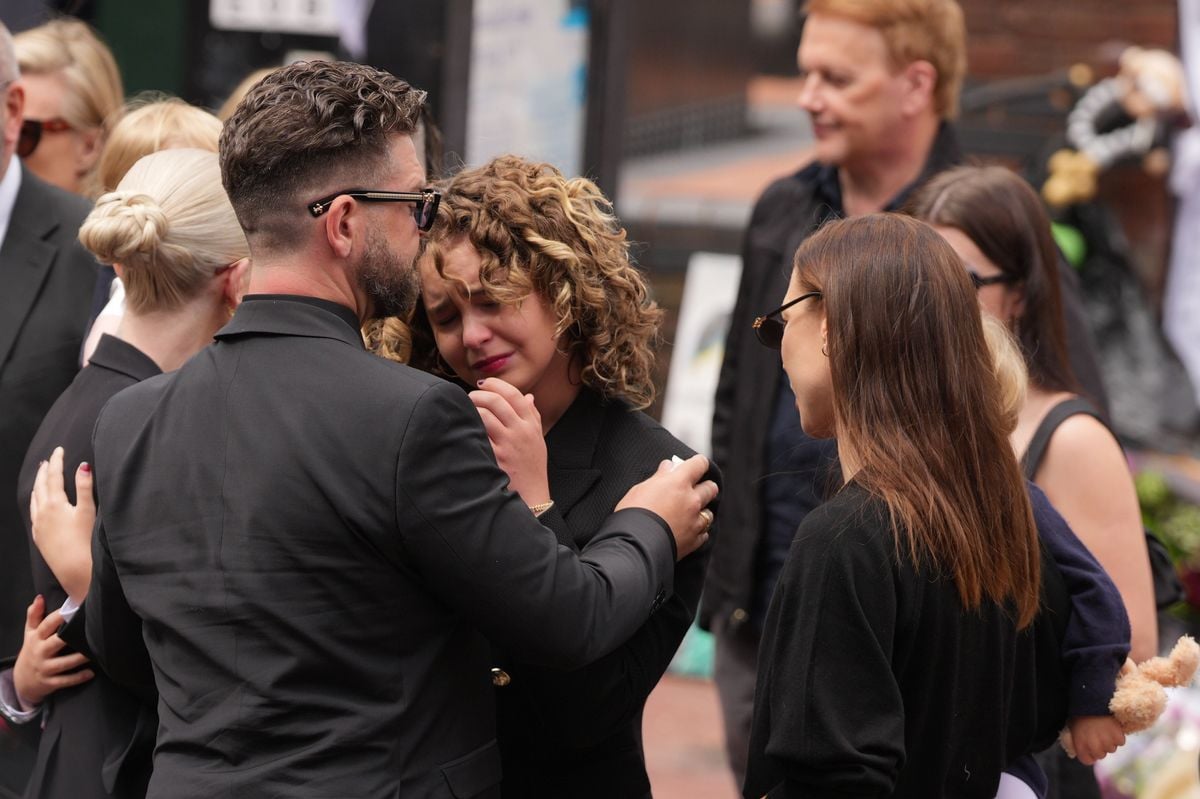 Jack Osbourne and family members stop to view tributes to the late Ozzy Osbourne.
