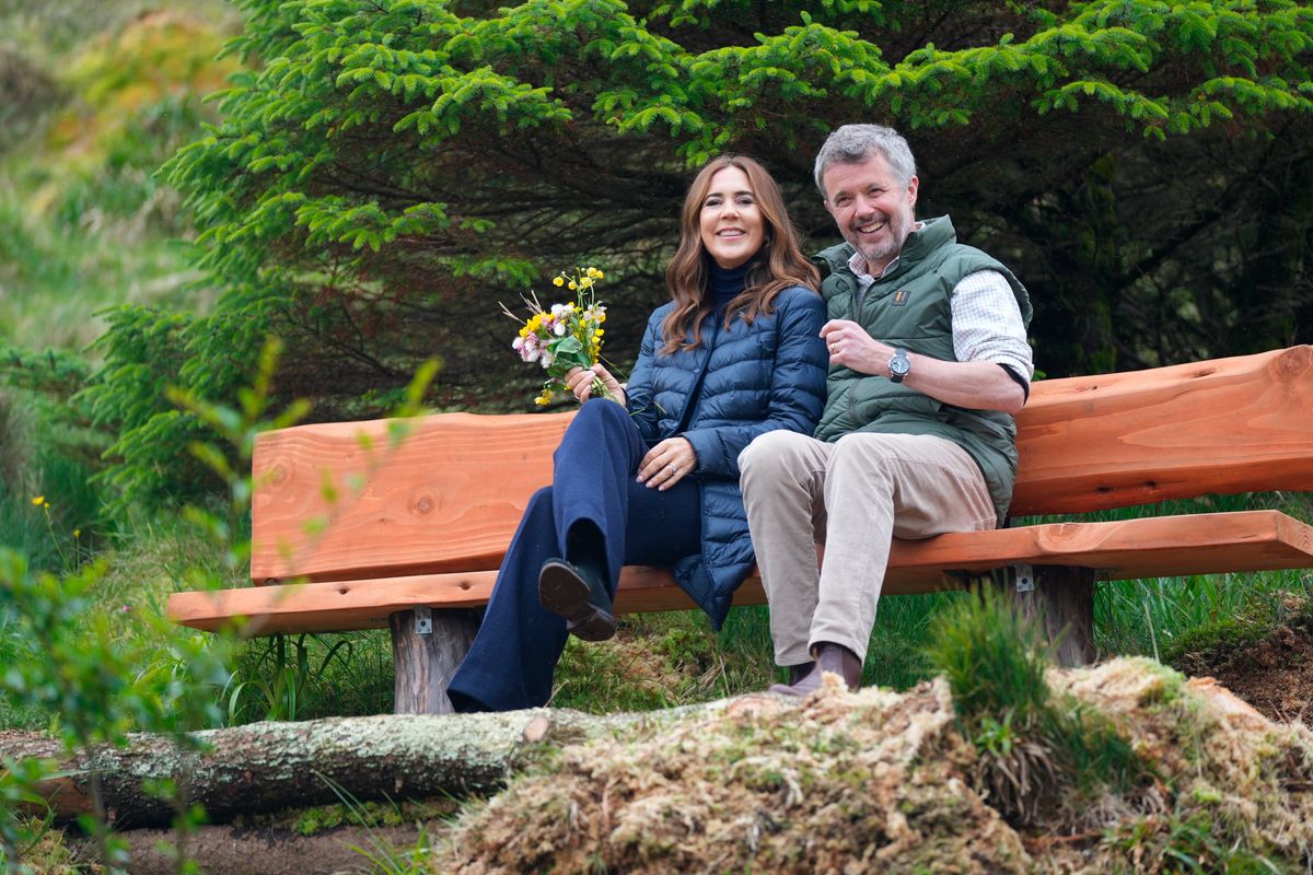 Denmark's King Frederik X and Queen Mary sit on a bench after planting a tree in the plantation in Tvoeroyri on the island of Suduroy in the Faroe Islands, on June 12, 2025. 