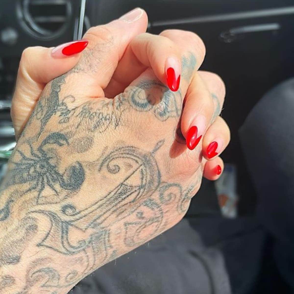 Kourtney Kardashian and Travis Barker hold hands