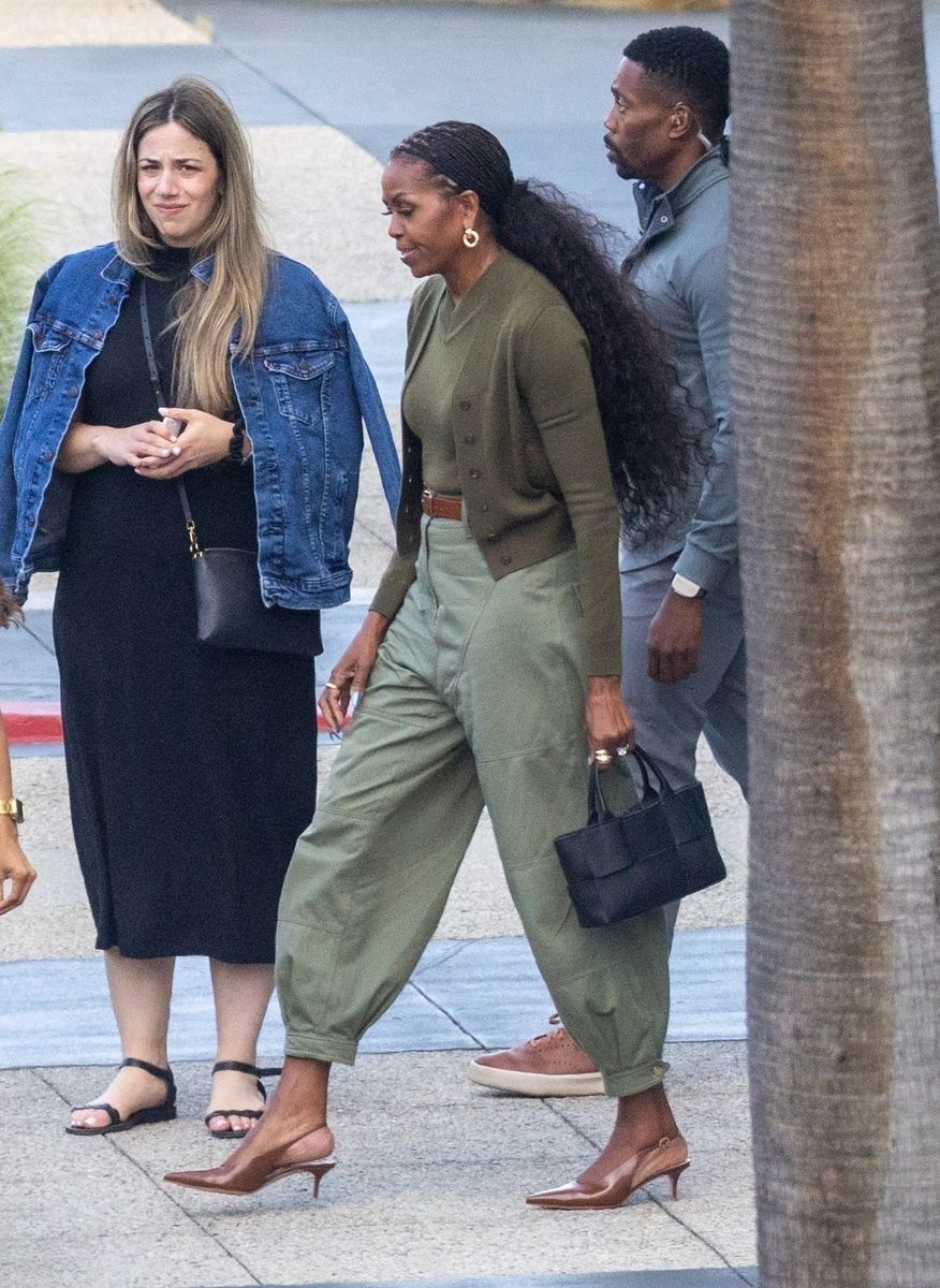Michelle Obama has been spotted out in Los Angeles as she continues to be hit with rumours of marital issues with husband, President Barack Obama. Michelle defiantly flashed her diamond engagement and wedding rings as she visited The Academy headquarters in North Hollywood. Barack was nowhere to be seen, as it was her brother, Craig Robinson accompanying her on the outing. President Obama was last seen with Michelle in December, nearly 5 months ago. He has been seen walking around Washington DC alone in his last public sighting. Michelle appeared to be in great spirts, looking stylish in olive green, with brown heels and a long wavy ponytail. She finished off her look with a Bottega Veneta "Arco Intrecciato" Leather Tote Bag retailing at ,700.