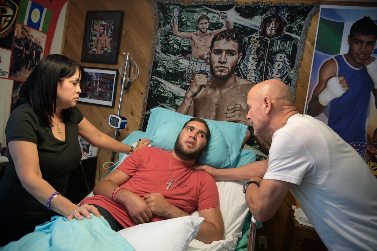 Nieves Melendez, left, and Richard Colon tend to their son, former professional boxer Prichard Colon, while he lies in a vegetative state in his bedroom