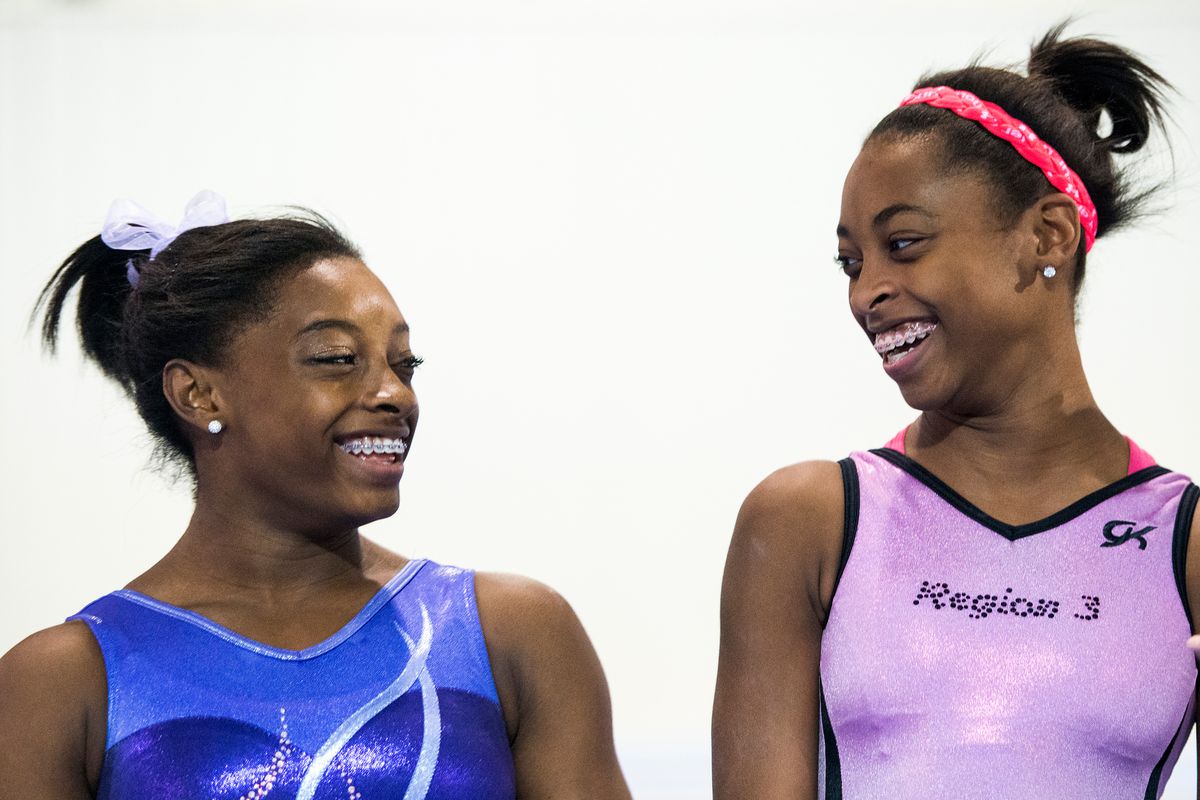 Simone Biles, left, laughts with her sister Adria while they train at Bannon's Gymnastix on Thursday, Aug. 22, 2013, in Houston. Biles won the US  women's national all-around championship last weekend. ( Smiley N. Pool / Houston Chronicle) (Photo by Smiley N. Pool/Houston Chronicle via Getty Images)