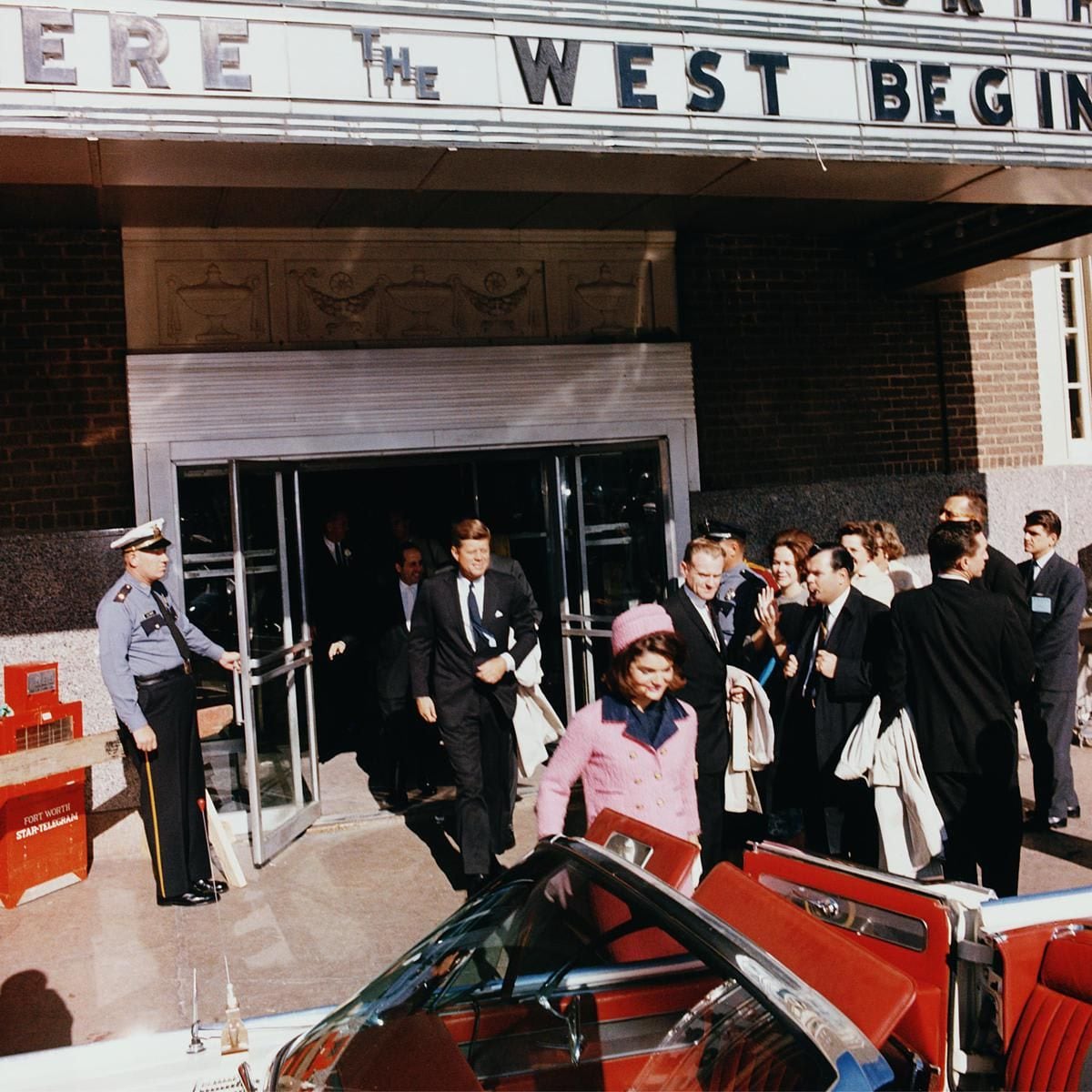 President John F. Kennedy and First Lady Jacqueline Kennedy emerge from a Fort Worth, Texas, theater, into a waiting car