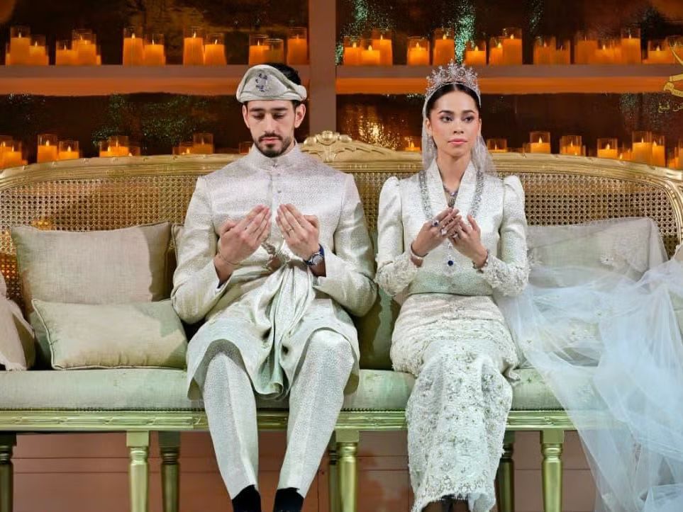 The royal couple pauses in prayer as centuries-old traditions unfold during their lavish wedding celebration.