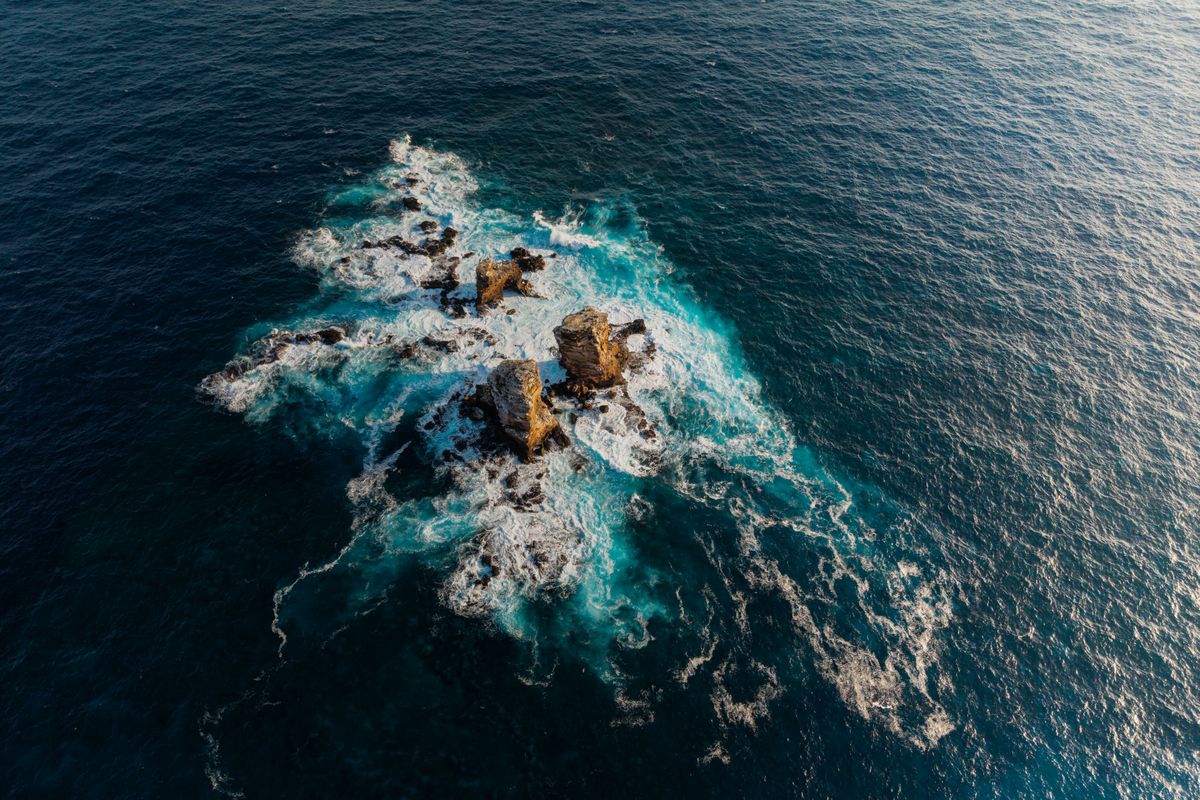 This aerial view shows Darwin's Pillars, remnants of Darwin's Arch, near the island of the same name in the northern Galapagos archipelago, Ecuador